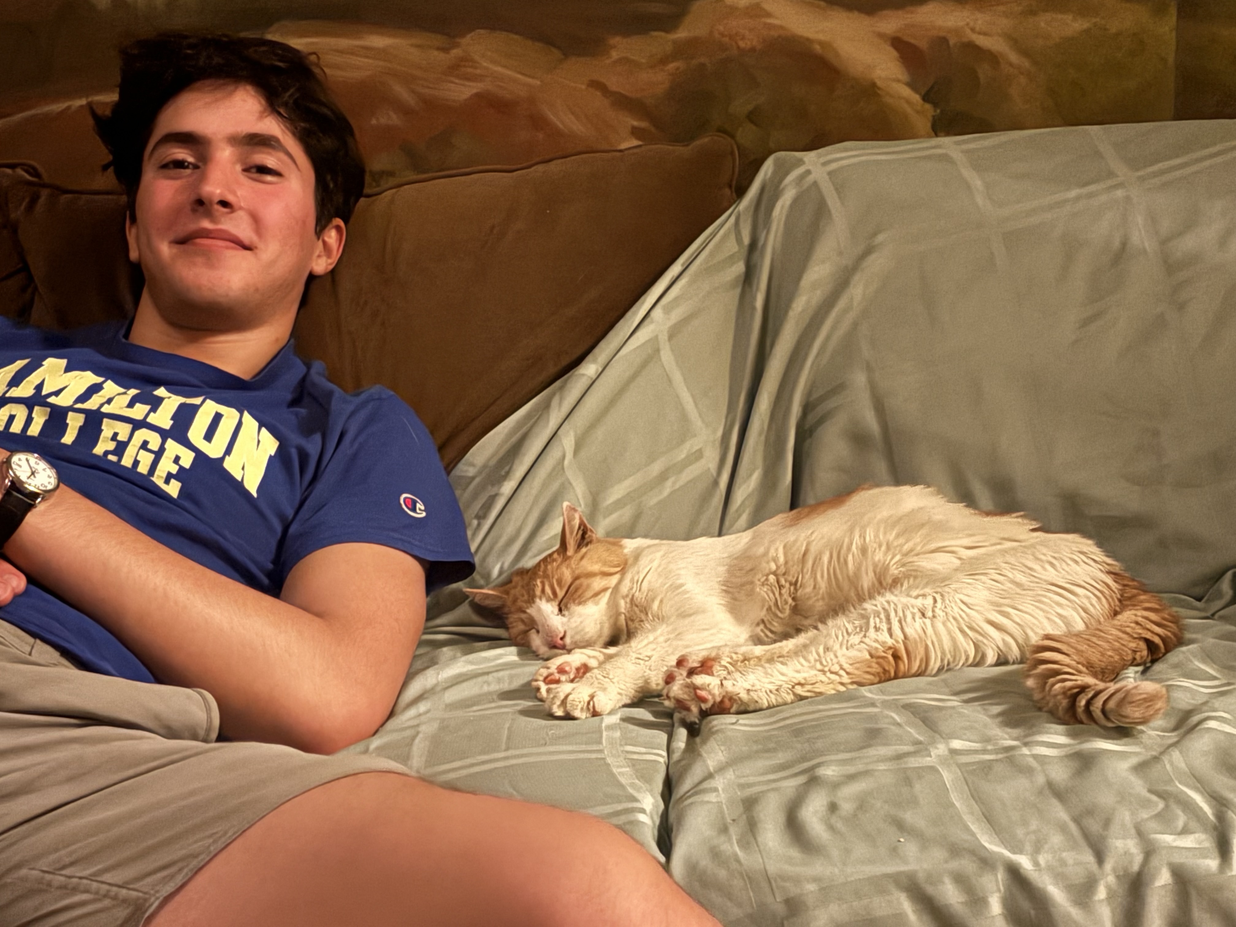 Nate on the couch with a cat